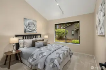 The second bedroom, along with all 3 bedrooms, has new carpet plus a large window and vaulted ceilings.
