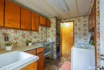 Utility room with storage and laundry sink.