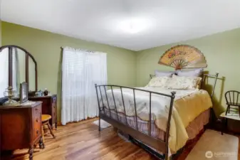 Main floor guest bedroom filled with natural light
