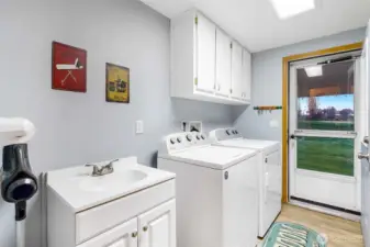 Convenient main-level laundry with built-in storage and workspace