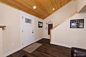 Main entry and stairway to loft bedroom with view and half bath.