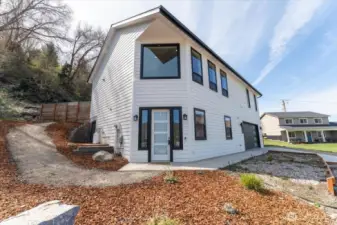 Low maintenance landscaping and terraced garden or flower beds in front.