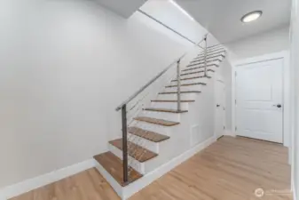 Stairs to downstairs and garage door straight in front.
