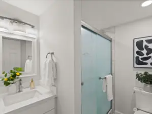 The updated primary bath with its tiled, double sized shower. The decorating and features in this home are all tastefully and beautifully done.