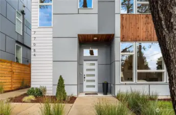 The formal covered entry is just off the wrap-around sidewalk that flows easily to the backyard and side door to the garage.