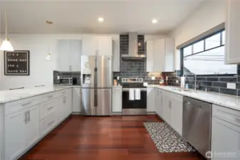 Pristine kitchen that opens to dining area & living room