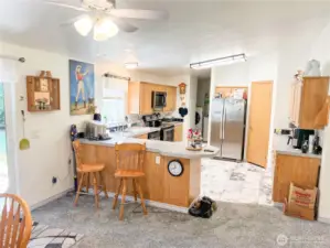 Kitchen enjoys a breakfast bar...plenty of cabinets and walk-in pantry
