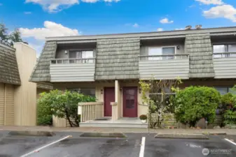 Exterior entrance with one step. Two assigned parking spaces, directly in front of home.