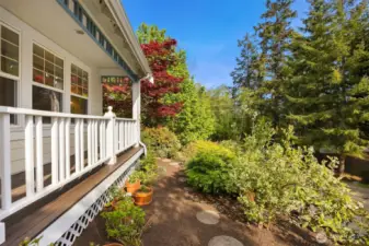 This stone path leads to a gate around the corner, connect the front of the home with the grassy back yard. All beautifully landscaped with love and care.