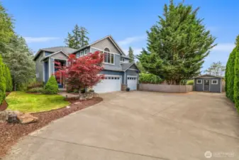 Manicured landscaping, a covered front porch, and timeless curb appeal set the tone.