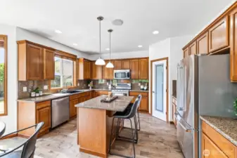 Granite counters, stainless appliances, and hardwoods flow into the open-concept design.
