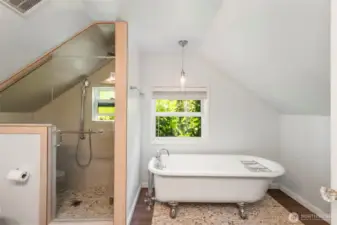 Full bath with custom tile shower and standalone claw tub.
