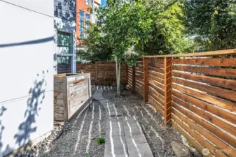 Spacious walkway in back with large planters