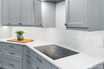 New induction cooktop and gleaming subway tile