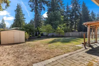 Fully fenced back yard extends beyond the line of fruit trees to the arbor vitae along the rear fenceline!
