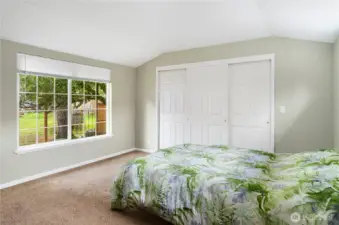 The primary bedroom features a very large walk-in closet and a large window to let in the light.
