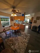 Looking from the spacious dining room to the kitchen and eating area.