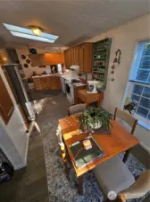 Eat-in kitchen table surrounded by light from the windows.