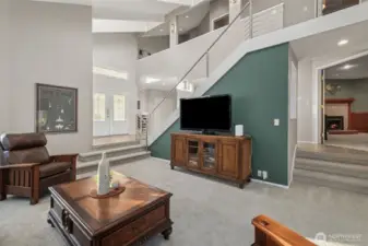 From this angle in the living room, you can see the designer cable railing system, raised ceiling, and upper level loft. The family room is steps away to the right.