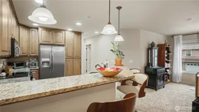 View of the peninsula seating highlights a functional and social kitchen layout.