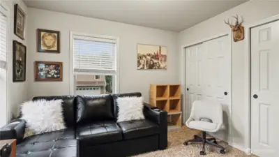 Spacious guest bedroom featuring a sliding door closet for convenient storage and a welcoming retreat for visitors.