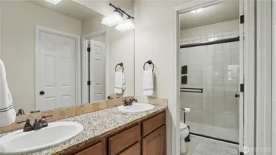 Primary bathroom offers plenty of storage and dual sinks.