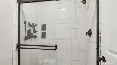 Separate water closet houses the shower and toilet.