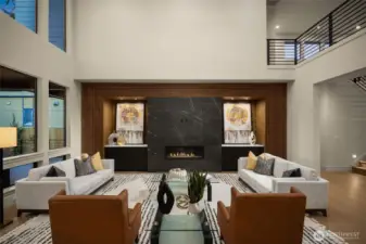 Modern gas fireplace with extensive millwork in this open to above space