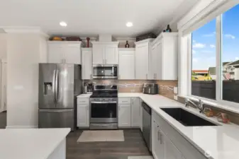 A spacious island anchors the kitchen, offering extra workspace and a place to gather, all within easy reach of the main living areas.