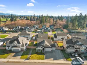Front aerial perspective showcasing the home’s curb appeal and its place within a well-maintained community.