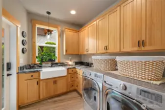 Laundry room with granite countertops, farm sink, door leading to side deck