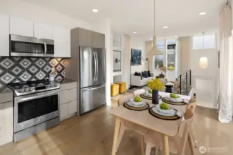 Looking from chef's kitchen and dining area toward living and entry.