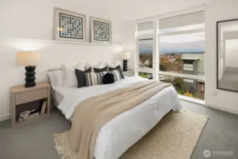 From the elegant third floor primary suite enjoy stunning eastern views.  Always interesting day or night - territorial views extend to Lake Washington, the Cascades and the City of Bellevue.  This floor also holds the primary 3/4 bath and washer/dryer.