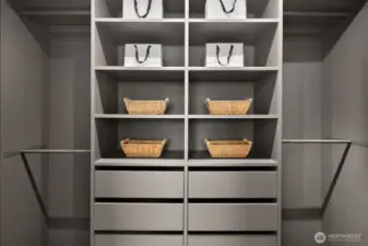 Beautifully organized with custom cabinetry and accent lighting, this walk-in closet is finished in designer colors for a polished look.
