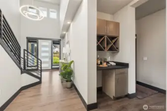 The front hallway flows into the stunning main floor living areas and at this juncture you can grab a glass of your special drink and continue into the living room.