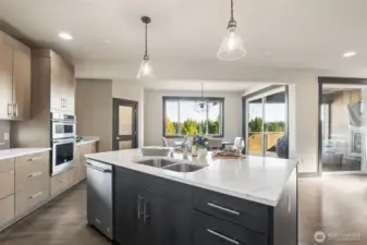 Oversized island, pendant lighting, and easy access to outdoor living—perfect for entertaining.