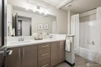 Upstairs hall bathroom includes double sinks and plenty of cabinets.