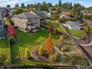 Aerial view showcasing the beautifully landscaped yard and surrounding greenery!