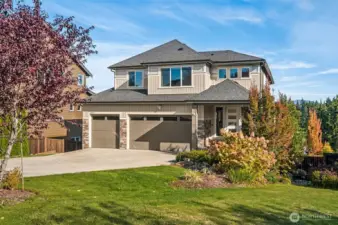 Stunning exterior with manicured landscaping, expansive driveway, and impressive curb appeal.