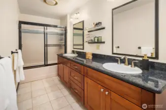 A rare combination of dual vanities and extra space for a mid-century primary bathroom