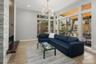 Well-appointed Great room with dramatic floor-to-ceiling stone surrounded gas fireplace