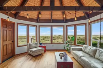 Panoramic ocean views from open concept living room with vaulted ceilings and real hardwood floors.