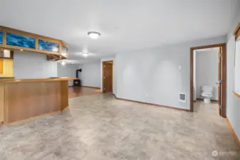 Hard surface flooring for quick clean-up. Wall heat. Doorways ahead open into Laundry (left) and half bath (right).