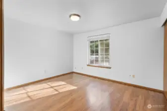 Morning sunlight streams into the second guest bedroom through the southeast facing grid window.