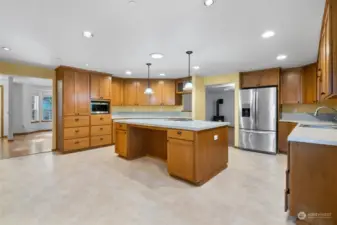 Wow! So much space in the Kitchen, wrapped with cabinetry with center island counter.