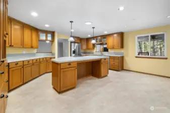 Room for a breakfast table under the window looking out to the back deck. Crown molding tops the upper cabinetry.