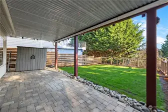 The covered lower patio includes a storage shed.