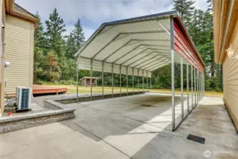 Between the home and the detached garage is a covered parking pad for RV/trailer/boat.