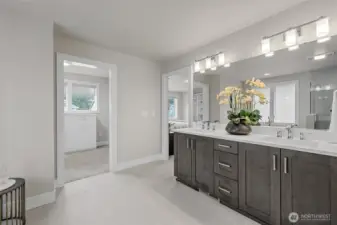 Dual vanities and access to a custom walk-in closet.