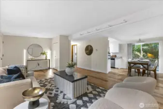 The living room leads to the dining room and kitchen.